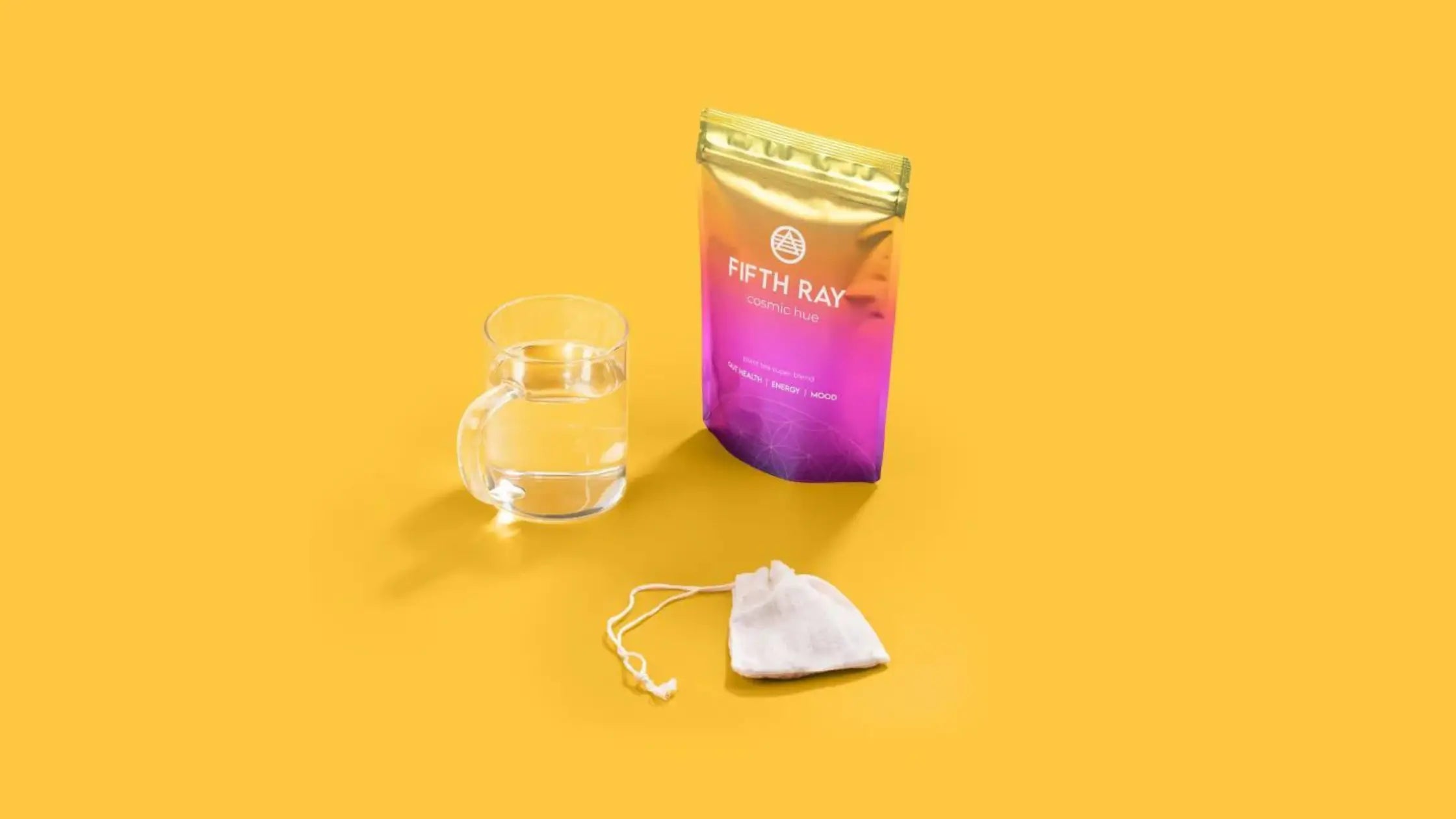 Cosmic hue tea with a tea bag and cup of hot water product shot