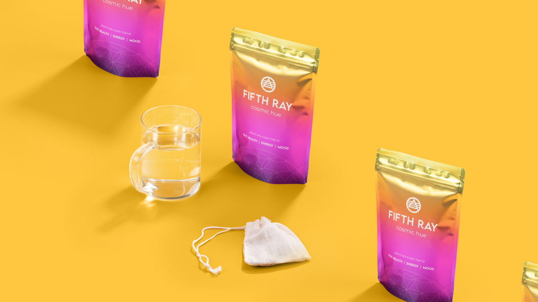 Fifth Ray Philosophy Back to Basics - three puches of cosmic hue tea next to glass cup and tea bag