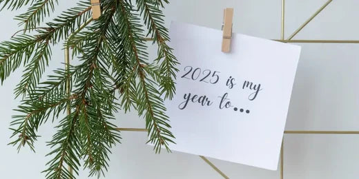 wooden peg next to tree branch holding paper saying 2025 is my year to...